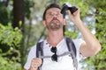 Man in countryside with binoculars looking up Royalty Free Stock Photo