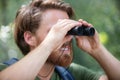 man in countryside looking through binoculars Royalty Free Stock Photo