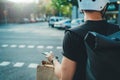 Man courier using a map app on mobile phone to find the delivery address in the city. Anonimous Courier delivery food