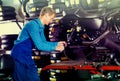 Man in coveralls checking motorcycle Royalty Free Stock Photo