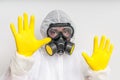 Man in coveralls with gas mask is showing stop gesture Royalty Free Stock Photo