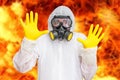 Man in coveralls with gas mask is showing stop gesture Royalty Free Stock Photo