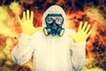 Man in coveralls with gas mask is showing stop gesture Royalty Free Stock Photo