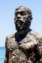 Man covered in oil on the beach at Porto da Barra in Salvador, Bahia, Brazil