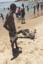 Man covered in oil on the beach at Porto da Barra in Salvador, Bahia, Brazil
