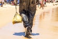 Man covered in oil on the beach at Porto da Barra in Salvador, Bahia, Brazil