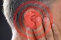 Man Covering Ear With Hand