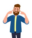 Man covering ears with fingers with annoyed expression for the noise of loud sound or music while eyes closed isolated standing. Royalty Free Stock Photo