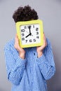 Man covering his face with big clock Royalty Free Stock Photo