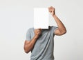 Man covering his face with empty white paper Royalty Free Stock Photo