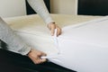 Man covering a mattress with a mattress protector Royalty Free Stock Photo