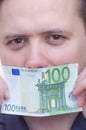 Man covering mouth with money banknote one hundred euro Royalty Free Stock Photo