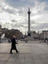 Man in a covid mask walking near Nelson Column, London Royalty Free Stock Photo