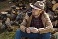 Man cowboy hat drinking morning coffee in countryside