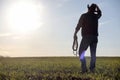 A man cowboy hat and a loso in the field. American farmer in a f