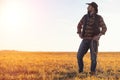 A man cowboy hat and a loso in the field. American farmer in a f