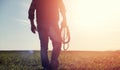 A man cowboy hat and a loso in the field. American farmer in a f