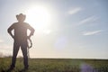 A man cowboy hat and a loso in the field. American farmer in a f