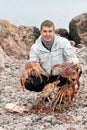 Man with crabs in the Barents Sea coast Royalty Free Stock Photo
