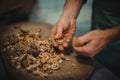 Man cracking walnut with hands Royalty Free Stock Photo