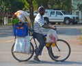 Man craring merchandise by bycicle for personal transportation