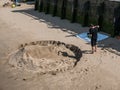 Man creates large face sand sculpture on South Bank of Thames Ri Royalty Free Stock Photo