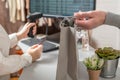 Man with credit card buying gift in a female clothing store. Woman cashier, seller scanning using barcode scanner at the checkout. Royalty Free Stock Photo