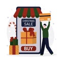 Man with credit card paying for purchase. Guy shopping to Christmas in mobile app. Happy person buying and ordering