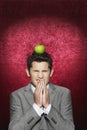 Man Cringing With Apple On His Head Royalty Free Stock Photo