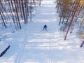 Man cross country skiing on track winter forest tree. Aerial top view Royalty Free Stock Photo