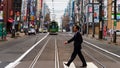 man cross street while tram riding
