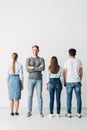 Man with crossed arms looking at camera near candidates in office