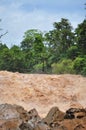 Man crosses the Khone Phapheng falls on the Mekong River in Laos on a rope during the Monsoon flooding