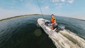 A man is crossing the lake in the autoboat