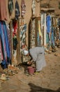 Man crouched before a cube in the Kasbah Ait Ben Haddou in Ouarzazate, Morocco October 2019