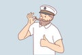 Man cruise ship captain fixes mustache and gives thumbs up suggestion to go on joint trip Royalty Free Stock Photo