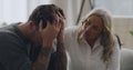 Man crying and being comforted by psychologist during therapy. Upset and anxious man with his head in his hands and