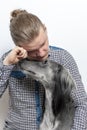 Man crying isolated on white. dog consoles his owner. stayhome concept Royalty Free Stock Photo