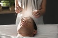 Man during crystal healing session in room Royalty Free Stock Photo