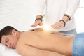 Man during crystal healing session in room Royalty Free Stock Photo