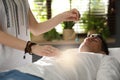 Man during crystal healing session in room Royalty Free Stock Photo