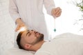 Man during crystal healing session in therapy room Royalty Free Stock Photo