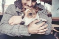 Man cuddling with his dog in winter Royalty Free Stock Photo