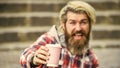 man with a cup of coffee outdoors. selective focus. Handsome calm bearded man outdoors with a cup. Man drinking hot