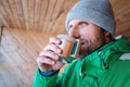 Man with cup of hot drink warms on open winter air Royalty Free Stock Photo