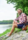 Man with cup outdoors. Man outdoors with cup of coffee. Drinking hot coffee. Enjoying nature at riverside. Guy with Royalty Free Stock Photo