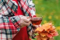 Man with cup of tea walk in autumn park with maple leaves Royalty Free Stock Photo