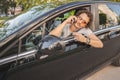 Man with curly hair using phone and looking in the rearview mirror Royalty Free Stock Photo