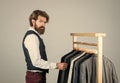 Man in custom tailored suit presenting expensive tailored tuxedo. Man in boutique. Man with suit. tailor in his workshop Royalty Free Stock Photo