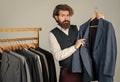 Man in custom tailored suit presenting tailored tuxedo. Man clothing in boutique. tailor in his workshop. Handsome Royalty Free Stock Photo